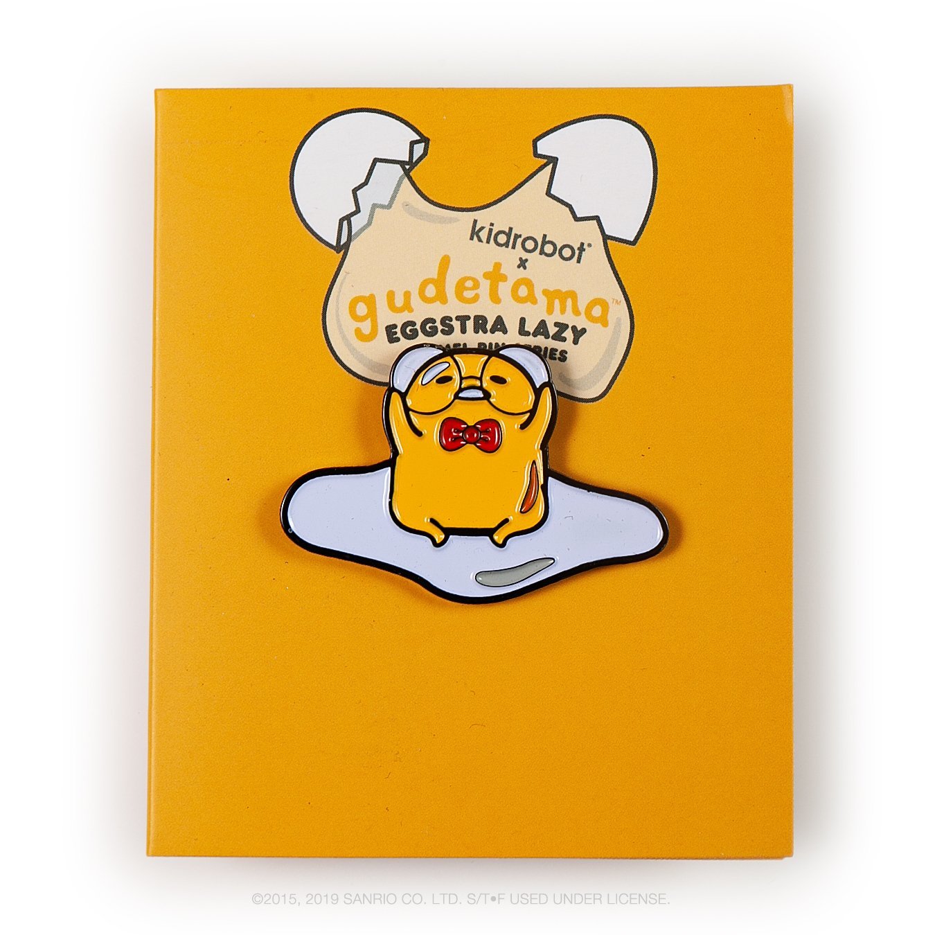 Gudetama Eggstra Lazy enamel pin from Kidrobot x Sanrio series, featuring a cute, lazy egg character on a white background.