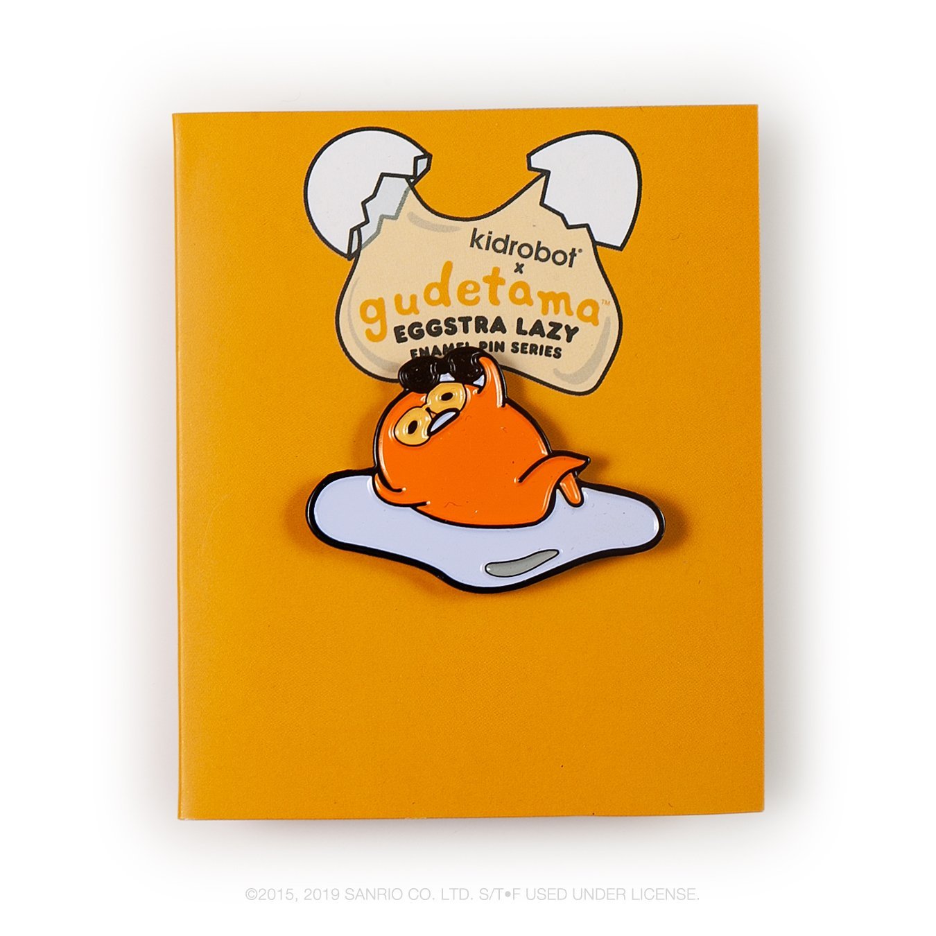Gudetama Eggstra Lazy enamel pin from Kidrobot x Sanrio series, featuring a cute, laid-back egg character on a white background.