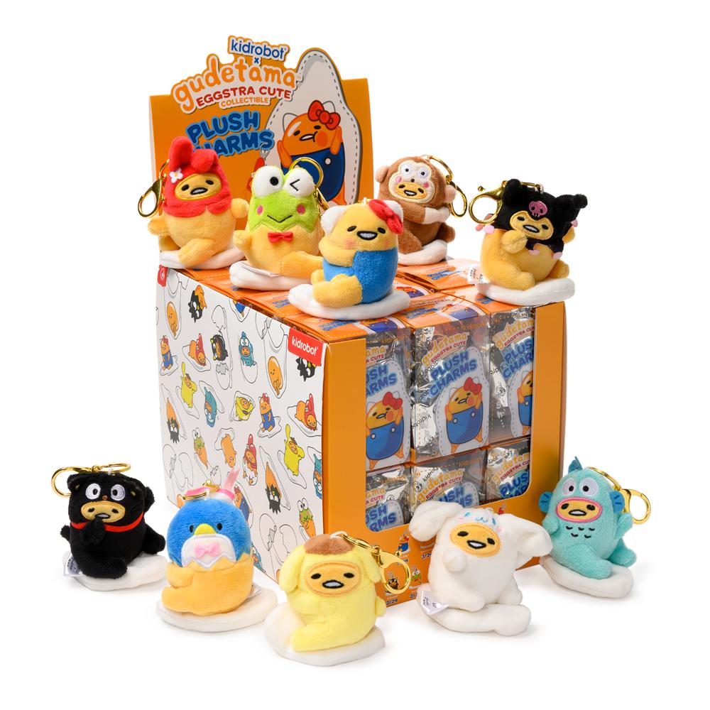 Gudetama the Lazy Egg plush charm keychain by Kidrobot x Sanrio, soft yellow plush with a cute egg shape and facial expression.