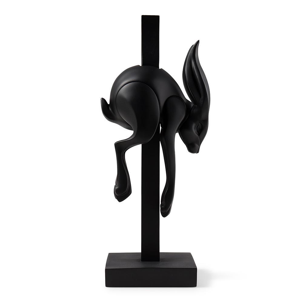 Matte black resin art figure called Jumper by Colus Havenga, featuring a sleek, modern sculpture with smooth black finish.