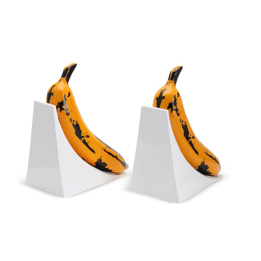 Yellow resin Kidrobot x Andy Warhol banana bookends featuring bold, artistic design on a white background.