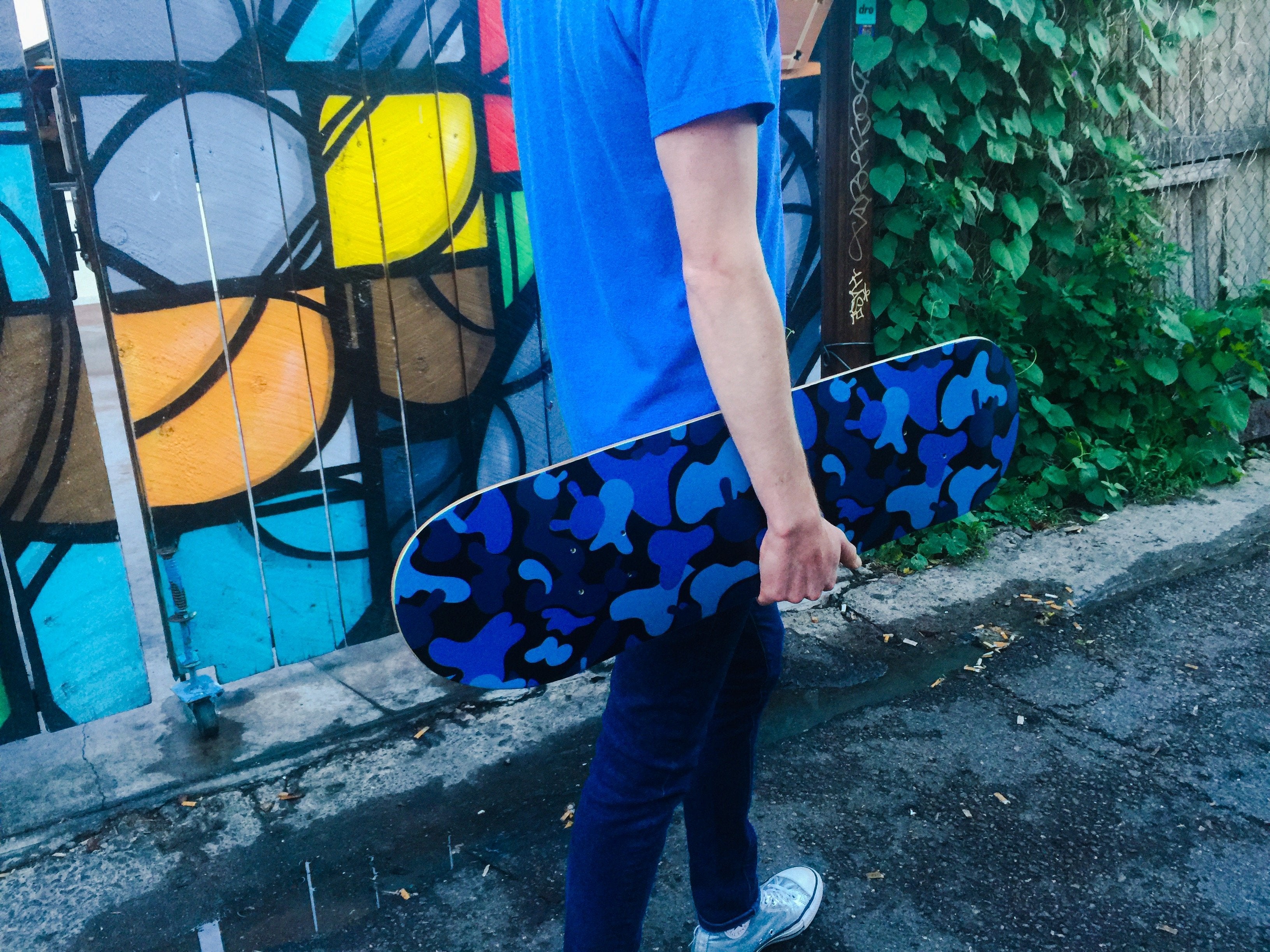 Limited edition Kidrobot Camo Dunny skateboard deck featuring Tristan Eaton's artwork with blue camo design on wood background.
